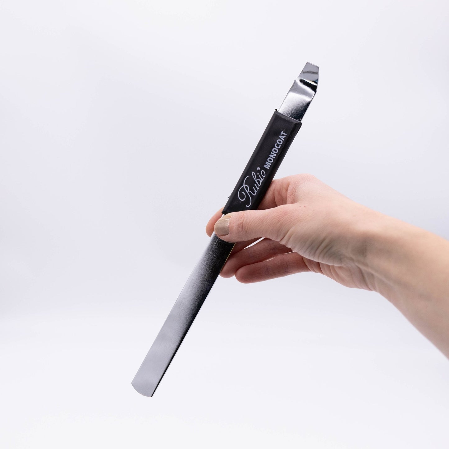 Metal stirring stick on a white background.