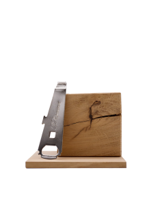 A bottle opener resting on a wooden block next to a knife